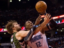 Toronto Raptors' Aaron Gray (left) fouls Orlando Magic's Dwight Howard during first half NBA basketball action in Toronto on Monday, March 26, 2012. (THE CANADIAN PRESS/Chris Young)