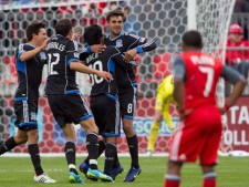 Toronto FC 's Joao Plata watches San Jose Earthquakes' Chris Wondolowski (second left) celebrate scoring his team's third goal with (left to right) Shea Salinas, Ramiro Corrales ad Rafael Baca) during second half MLS action in Toronto on Saturday, March 24, 2012. (THE CANADIAN PRESS/Chris Young)