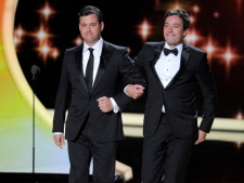 Jimmy Kimmel, left, and Jimmy Fallon present the award for outstanding supporting actress in a comedy series at the 63rd Primetime Emmy Awards on Sunday, Sept. 18, 2011, in Los Angeles. (AP Photo/Mark J. Terrill)