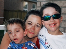 Thomas Courville, left, is pictured with his mother Michelle and brother in this photo provided by the Courville family. Computer devices containing photos and videos of Thomas, who died in 2008 at the age of five, were stolen during a break-in at the family's home. (Handout)