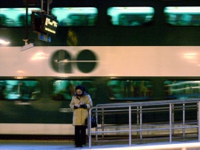 A woman reads a book as a GO commuter train pulls away from the platform at Toronto's Union Station on March 4, 2008. (THE CANADIAN PRESS/J.P. Moczulski)