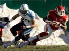 Kansas City Chiefs wide receiver Samie Parker (18) is chased into the end zone by Tennessee Titans safety Calvin Lowry (37) after Parker completed a short pass for a touchdown during the second quarter of an NFL football game Sunday, Dec. 16, 2007, in Kansas City, Mo. (AP Photo/Charlie Riedel)