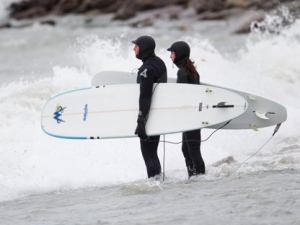 Two surfers assess the conditions before jumping into Lake Ontario at the Scarborough Bluffs on March 31, 2012. (Sandie Benitah/ CP24)