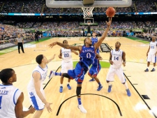 Kansas' Thomas Robinson (0) drives to the basket over Kentucky defenders during the first half of an NCAA Final Four college basketball tournament championship game on Monday, April 2, 2012, in New Orleans. (AP Photo/Chris Steppig/NCAA Photos)