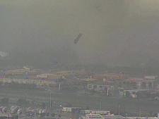 An 18-wheeler is thrown into the air as a result of a tornado in Dallas, Texas on Tuesday, April 3, 2012.