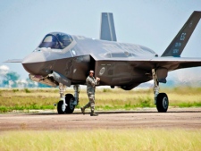 In this July 14, 2011, file photo released by U.S. Air Force, an aircraft maintainer walks by the U.S. Air Force F-35 Lightning II joint strike fighter (JSF) at Eglin Air Force Base, Fla. (THE CANADIAN PRESS/AP, U.S. Air Force, Samuel King Jr.)