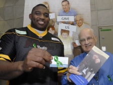 Hamilton Ticats offensive lineman, Wayne Smith (left), and Trillium Gift of Life Network volunteer and lung recipient, Merv Sheppard, work together as a team in the lobby of McMaster Hospital in Hamilton on Tuesday, Oct. 17, 2006, asking the public to sign their organ donation card and to speak to their family about their wishes. (PR DIRECT PHOTO/Trillium Gift of Life Network)