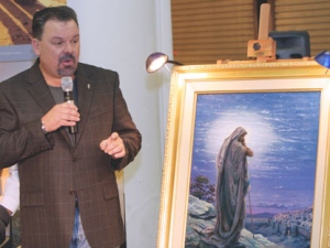 In this Sept. 15, 2006 file photo, artist Thomas Kinkade unveils his painting, "Prayer For Peace," at the opening of the exhibit "From Abraham to Jesus," in Atlanta. Kinkade, whose brushwork paintings of idyllic landscapes, cottages and churches have been big sellers for dealers across the United States, died Friday, April 6, 2012, a family spokesman said. He was 54. (AP Photo/Gene Blythe, File)
