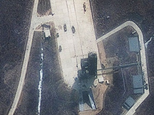 This March 31, 2012 satellite image released by GeoEye Monday April 9, 2012 shows continued activity at the launch pad of the Tongchang-ri Launch Facility on North Korea's western coast. The image shows vehicles on the launch pad, nearby fuel and oxidizer containers and a crane above the launch tower that has been placed "directly over the mobile launch platform, the position necessary to erect the rocket", according to an analysis by IHS Jane's Defense Weekly. North Korea says it plans to launch a satellite into space from the launch pad to mark the 100th anniversary of national founder Kim Il Sung's birth. (AP Photo/GeoEye/IHS Global)