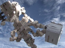 Dextre, the Canadian Space Agency�s robotic handyman, ferries cargo from the Kounotori2 cargo ship to the International Space Station in February 2011. (THE CANADIAN PRESS/HO-NASA)