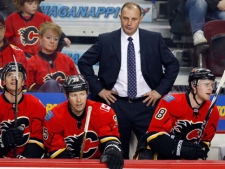 Calgary Flames' head coach Brent Sutter, centre, reacts to the teams loss as players, left to right, Blake Comeau, David Moss, Matt Stajan, and Lee Stempniak sit on the bench during third period NHL hockey action in Calgary, Alta., Wednesday, March 28, 2012. The Flames say the team and Sutter have agreed to part ways. THE CANADIAN PRESS/Jeff McIntosh