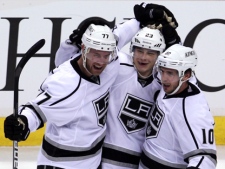Los Angeles Kings right wing Dustin Brown (23) celebrates his goal against the Vancouver Canucks with teammates Jeff Carter (77) and Mike Richards (10) during NHL playoff action at Rogers Arena in Vancouver, B.C., on Wednesday, April, 11, 2012. (THE CANADIAN PRESS/Jonathan Hayward)