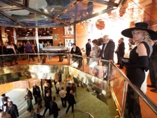 A passenger in evening gown, stands on the main deck of the MS Balmoral Titanic memorial cruise ship, prior to the gala dinner in the Atlantic Ocean, Friday, April 13, 2012. Nearly 100 years after the Titanic went down, the cruise with the same number of passengers aboard is setting sail to retrace the ship's voyage, including a visit to the location where it sank. The Titanic Memorial Cruise departed Sunday, April 8, from Southampton, England, where the Titanic left on its maiden voyage and the 12-night cruise will commemorate the 100th anniversary of the sinking of the White Star liner early Sunday, April 15, 2012. (AP Photo/Lefteris Pitarakis)