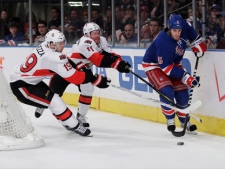 Ottawa Senators forwards Jason Spezza and Daniel Alfredsson, right, chase down New York Rangers defenceman Dan Girardi during the first period of Game 2 of a first-round NHL hockey playoff series Saturday, April 14, 2012, in New York. (AP Photo/Frank Franklin II)