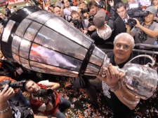 B.C. Lions head coach Wally Buono shows the Grey Cup after beating the Winnipeg Blue Bombers 34-23 in the 99th CFL Grey Cup on Nov. 27, 2011 in Vancouver. Buono of the Grey Cup-champion B.C. Lions is the CFL's coach of the year. Buono received the Annis Stukus Trophy for the fourth time in his 22-year coaching career at a luncheon today. (THE CANADIAN PRESS/Nathan Denette)
