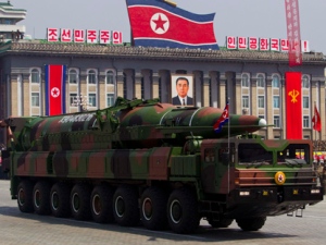 In this April 15, 2012, file photo, a North Korean vehicle carrying a missile passes by during a mass military parade in Pyongyang's Kim Il Sung Square to celebrate the centenary of the birth of the late North Korean founder Kim Il Sung. The enormous, 16-wheel truck used to carry the missile likely came from China in a possible violation of U.N. sanctions meant to rein in Pyongyang's missile program, experts say. (AP Photo/David Guttenfelder, File)