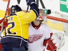 Nashville Predators center Mike Fisher (12) collides with Detroit Red Wings goalie Jimmy Howard, right, in the first period of Game 5 of a first-round NHL hockey playoff series on Friday, April 20, 2012, in Nashville, Tenn. (AP Photo/Mark Humphrey)