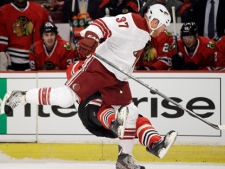 Chicago Blackhawks forward Marian Hossa falls down after taking a hit from Phoenix Coyotes forward Raffi Torres during the first period of Game 3 of an NHL hockey Stanley Cup first-round playoff series in Chicago on Tuesday, April 17, 2012. (AP Photo/Nam Y. Huh)