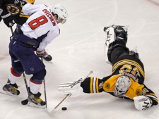 Boston Bruins goalie Tim Thomas (30) dives to make a save on a shot by Washington Capitals left wing Alex Ovechkin (8) during the second period of Game 7 of an NHL hockey Stanley Cup first-round playoff series, in Boston on Wednesday, April 25, 2012. (AP Photo/Charles Krupa)