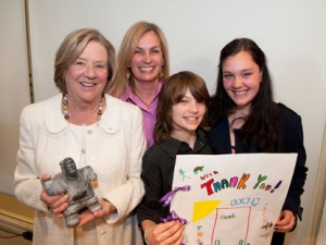 Philanthropist Margaret McCain, left, received a unique soapstone carving in thanks for a $10 million gift to Toronto's Centre for Addiction and Mental Health on Wednesday, April 25, 2012. CAMH clients Cheryl Marsh and son Colin Stainton, 11, celebrated the announcement with sister Marie Stainton, 14. (CNW Group/CAMH Foundation)