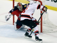 Florida Panthers goalie Jose Theodore blocks a shot by New Jersey Devils forward Zach Parise during the third period of Game 1 of an NHL first-round playoff series in Sunrise, Fla., Friday, April 13, 2012. The Devils won 3-2. (AP Photo/J Pat Carter)