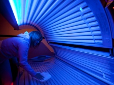 Lisa Shenton of Sunshine Tanning Studios cleans a tanning bed in North Vancouver, B.C. on Tuesday, March, 20, 2012. (THE CANADIAN PRESS/Jonathan Hayward)