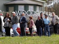 People wait outside the Woodstock Playhouse to board buses to go to a wake for musician Levon Helm at his home in Woodstock, N.Y., on Thursday, April 26, 2012. Helm, a former member of The Band, four-time Grammy Award winner and member of the Rock and Roll Hall of Fame died last week at age 71 after a battle with cancer. (AP Photo/Mike Groll)