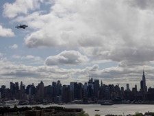 Space shuttle Enterprise, riding on the back of the NASA 747 Shuttle Carrier Aircraft, cruises over the New York City skyline as it makes its way to John F. Kennedy International Airport on Friday, April 27, 2012. (AP Photo/Julio Cortez)