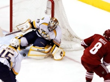 Nashville Predators goalie Pekka Rinne, of Finland, makes a save on a shot by Phoenix Coyotes' Gilbert Brule (8) as Predators' Craig Smith (15) waits for the rebound during the first period of Game 1 in an NHL hockey Stanley Cup Western Conference semifinal playoff series on Friday, April 27, 2012, in Glendale, Ariz. (AP Photo/Ross D. Franklin)