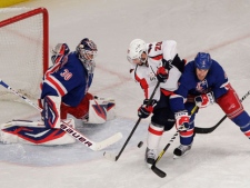 Washington Capitals' Troy Brouwer (20) is defended by New York Rangers' Dan Girardi (5) and goalie Henrik Lundqvist (30) during the second period of Game 1 in the second round of the NHL hockey Stanley Cup playoffs Saturday, April 28, 2012, in New York. (AP Photo/Frank Franklin II)