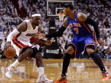 Miami Heat small forward LeBron James, left, drives to the basket as Carmelo Anthony (7) defends in the first half during an NBA basketball game in the first round of the Eastern Conference playoffs in Miami, Saturday, April 28, 2012. (AP Photo/Lynne Sladky)