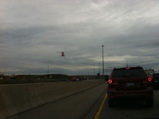 An Ornge air ambulance is seen in this picture over the QEW following a tractor-trailer rollover on Monday, April 30, 2012 . 
