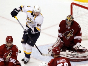 Phoenix Coyotes goalie Mike Smith, top right, makes a save on a shot by Nashville Predators' Andrei Kostitsyn (46), of Russia, as Coyotes' Rostislav Klesla (16), of the Czech Republic, and Derek Morris (53) defend in the third period during Game 2 in an NHL hockey Stanley Cup Western Conference semifinal playoff series, Sunday, April 29, 2012, in Glendale, Ariz. The Coyoteswon 5-3. (AP Photo/Ross D. Franklin)