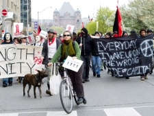 Occupy Toronto protesters in support of May Day walk the streets in downtown Toronto on Tuesday, May 1, 2012. THE CANADIAN PRESS/Nathan Denette