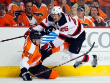 Philadelphia Flyers' Matt Carle is down on the ice after a hit from New Jersey Devils' Cam Janssen during the first period in Game 2 of an NHL hockey Stanley Cup second-round playoff series on Tuesday, May 1, 2012, in Philadelphia. (AP Photo/Tom Mihalek)