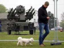 A man walks past a Rapier short range air defence system ahead of a training exercise designed to test military procedures prior to the upcoming Olympics, at Blackheath, London, Thursday, May 3, 2012. (AP Photo / Lewis Whyld, pa)