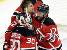 New Jersey Devils' Alexei Ponikarovsky, top, of Ukraine, celebrates his game-winning goal against the Philadelphia Flyers with teammates Ilya Kovalchuk (17), of Russia, and Martin Brodeur (30) in a 4-3 overtime victory in Game 3 of a second-round NHL hockey Stanley Cup playoff series on Thursday, May 3, 2012 in Newark, N.J. The Devils took a 2-1 lead in the series. (AP Photo/Julio Cortez)