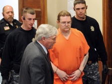Convicted murderer Ronald Smith, of Red Deer, Alta., is escorted into his clemency hearing at Powell County District Court on Wednesday, May 2, 2012, in Deer Lodge, Mont. (AP Photo/The Missoulian, Michael Gallacher) 