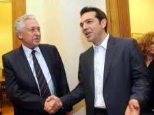 Greek leader of Coalition of the Radical Left party (SYRIZA) Alexis Tsipras, right, and leader of the Democratic Left party Fotis Kouvelis smile before their meeting at the Greek Parliament in Athens, Tuesday, May 8, 2012. (AP Photo/Evi Fylaktou)