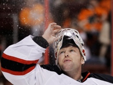 New Jersey Devils goalie Martin Brodeur blows water into the air before the second period of Game 5 of a second-round NHL hockey Stanley Cup playoff series against the Philadelphia Flyers on Tuesday, May 8, 2012, in Philadelphia. (AP Photo/Matt Slocum)