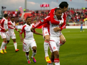 Toronto FC midfielder Reggie Lambe (right) is congratulated by teammates including Eric Avila (on his back) after scoring on the Montreal Impact during the first half of game 3 Canadian Championship action in Toronto on Wednesday, May 9, 2012. (THE CANADIAN PRESS/Frank Gun)