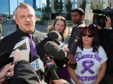 Rodney Stafford, father of slain Victoria (Tori) Stafford, with girlfriend Patrina Fraser, pauses as he speaks to the media outside the courthouse at the Michael Rafferty murder trial in London, Ont., Friday, May 11, 2012. (THE CANADIAN PRESS/Dave Chidley)