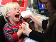 A new study suggests Ontario's universal flu shot program isn't making much progress with toddlers. Four-and-a-half-year-old Mika Hoffer reacts as she is injected with the H1N1 flu vaccine at a clinic in Ottawa, Monday, October 26, 2009. (THE CANADIAN PRESS/Fred Chartrand)