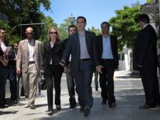 Alexis Tsipras (front), leader of Greece's Coalition of the Radical Left Party SYRIZA, arrives at the presidential palace for a meeting with President Karolos Papoulias in Athens on Tuesday, May 15, 2012. (AP Photo/Petros Giannakouris)