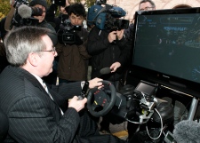 Ontario Transportation Minister Jim Bradley drives in a simulation car ride called D.U.M.B. (Distractions Undermining Motorists Behaviour) while trying to make a phone call at an announcement in Toronto, Tuesday, Oct.28, 2008. (THE CANADIAN PRESS/Jim Ross)