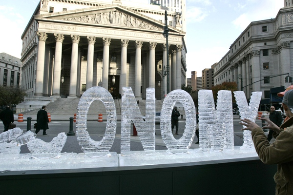 An ice sculpture entitled 'Main Street Meltdown,' is melting on the 79th anniversary of Black Tuesday, the stock market crash that caused the Great Depression, as pedestrians pass by Wednesday, Oct. 29, 2008 in New York. (AP / Frank Franklin II)