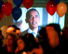 An image of the U.S. President-elect Barack Obama plays on the television, as people attend an election day event organized by the U.S. embassy in Skopje, Macedonia, early Wednesday, Nov. 5, 2008. (AP / Boris Grdanoski)