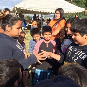 Youth in Sandy Lake First Nations reserve in Northern Ontario play in a rock paper scissors tournament during Beach Day fesitivities on August 17, 2015. (Sandie Benitah/CP24.com.)