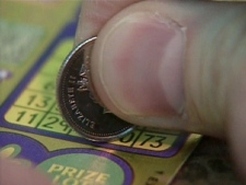 A lottery player tries their luck with a scratch and win ticket in Toronto.