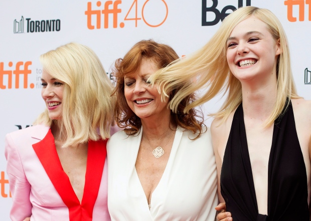 Actress Susan Sarandon, centre, gets hit in the face by actress Elle Fanning's hair, right, as they pose with fellow actress Naomi Watts on the red carpet for the film "About Ray" during the 2015 Toronto International Film Festival, in Toronto, on Saturday, September 12, 2015. THE CANADIAN PRESS/Darren Calabrese